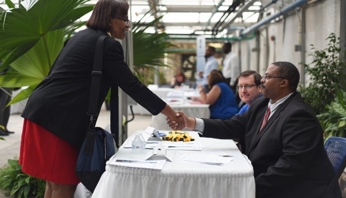 People shaking hands at a job fair