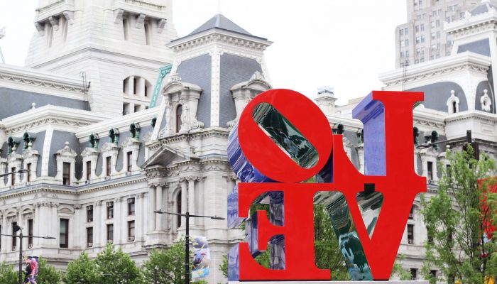 the love sculpture in the foreground with Philadelphia City Hall in the background