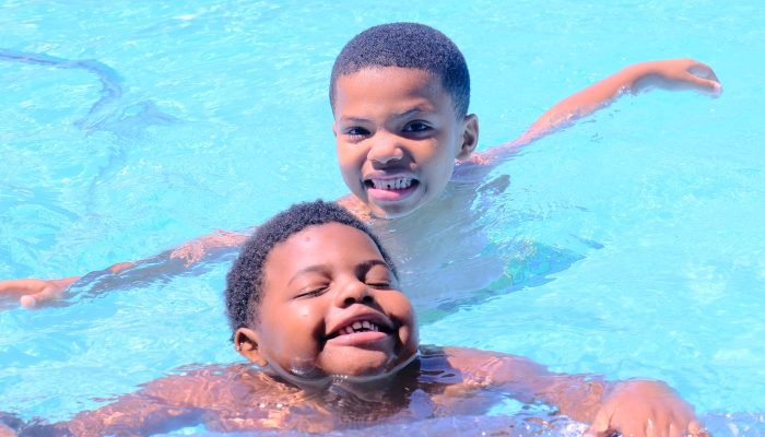 Two African-American boys swim during sensory friendly swim at Kendrick Pool in Roxborough.