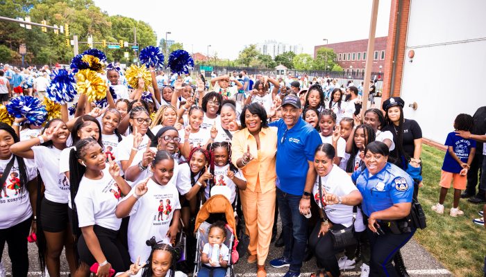 Mayor Cherelle L. Parker smiling with a large group at a Labor Day Parade