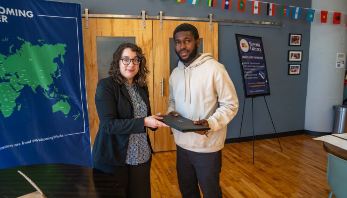 Monica Quinones-Rivera and a recipient of a new laptop at the Beyond Literacy device distribution.